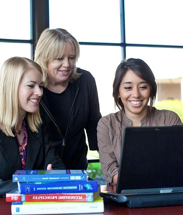 students with faculty at computer